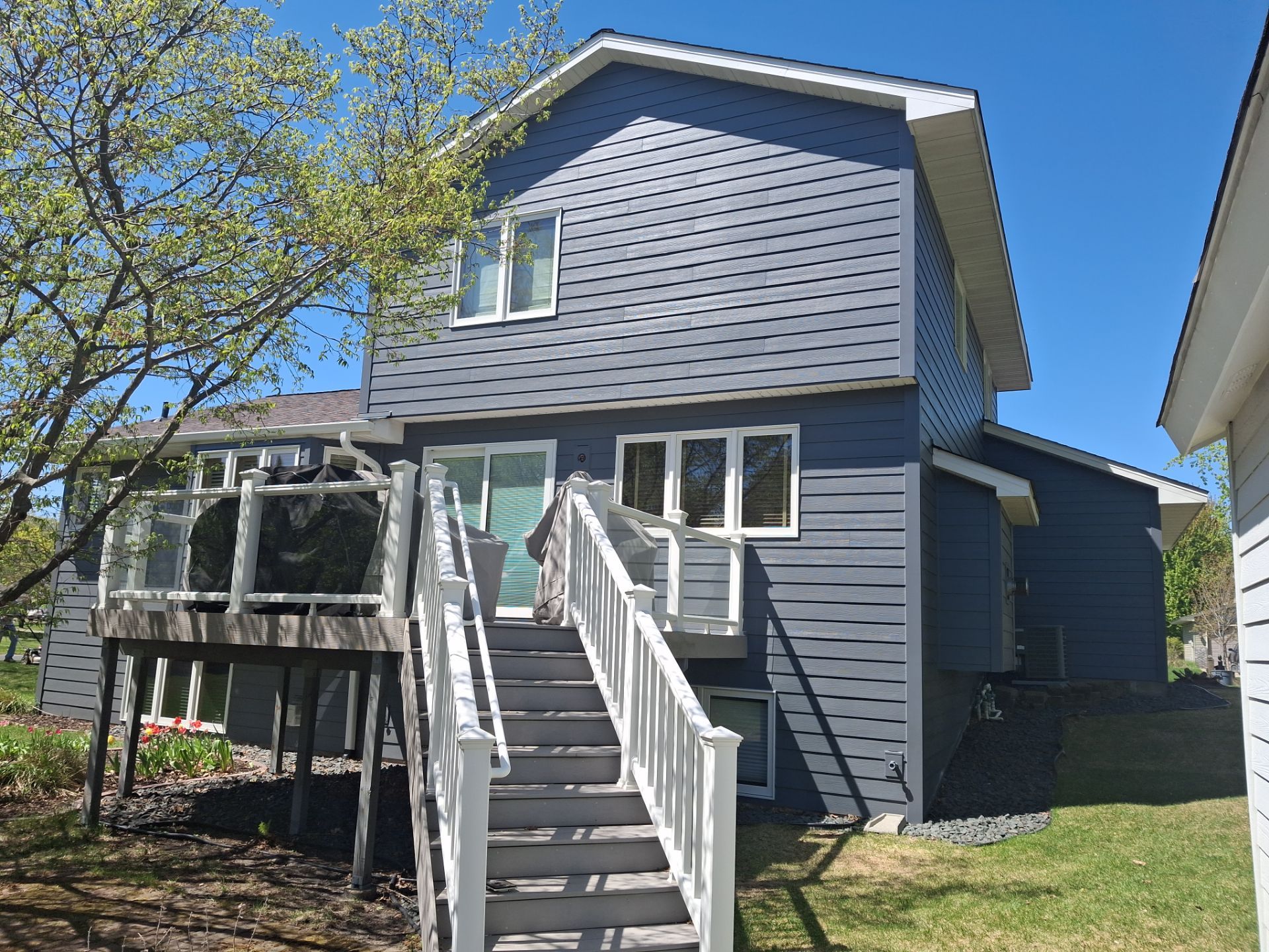 Modern dark gray siding and backyard deck exterior remodel Blaine MN by Wright at Home