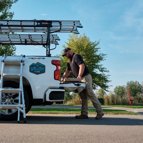 Patrick Lokker unloading materials from a service truck, roofing and siding project management in the Twin Cities by Wright at Home Roofing & Exteriors