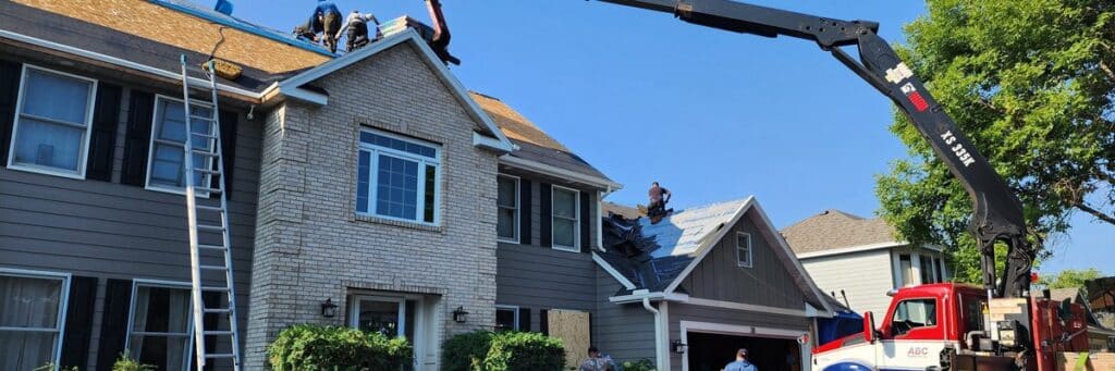 Boom truck delivering shingles while Wright at Home roofers work on a permitted roof replacement in Minnesota