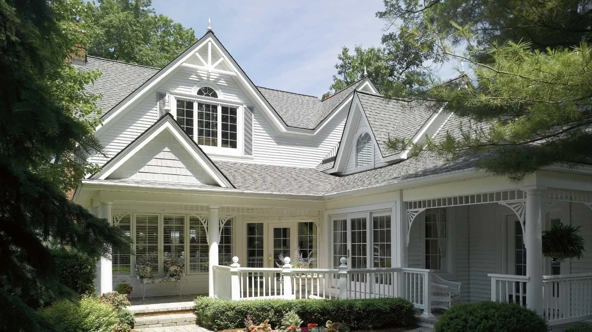 Timeless house design with grey roof, white windows, sidings, and doors by roofing contractors Minneapolis, MN